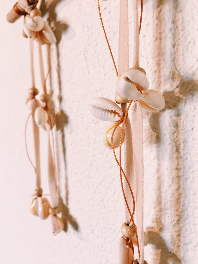 close-up of dreamcatcher made of bamboo and sea shells