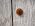 Rusty nail head on a bleached wooden door